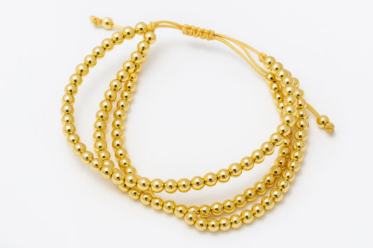Pulsera triple de cuentas doradas