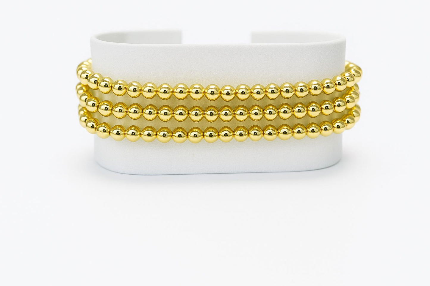 Pulsera triple de cuentas doradas