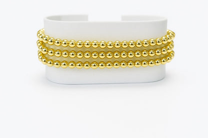 Pulsera triple de cuentas doradas