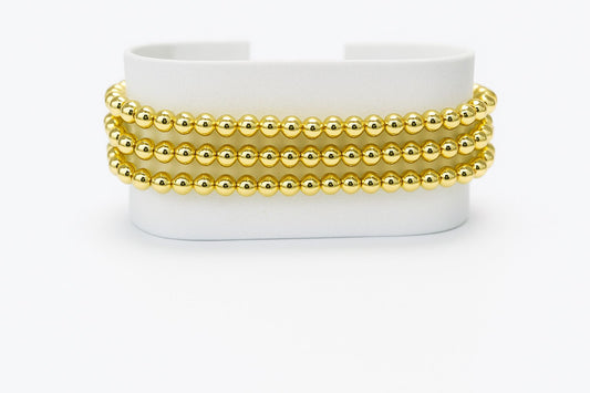 Pulsera triple de cuentas doradas
